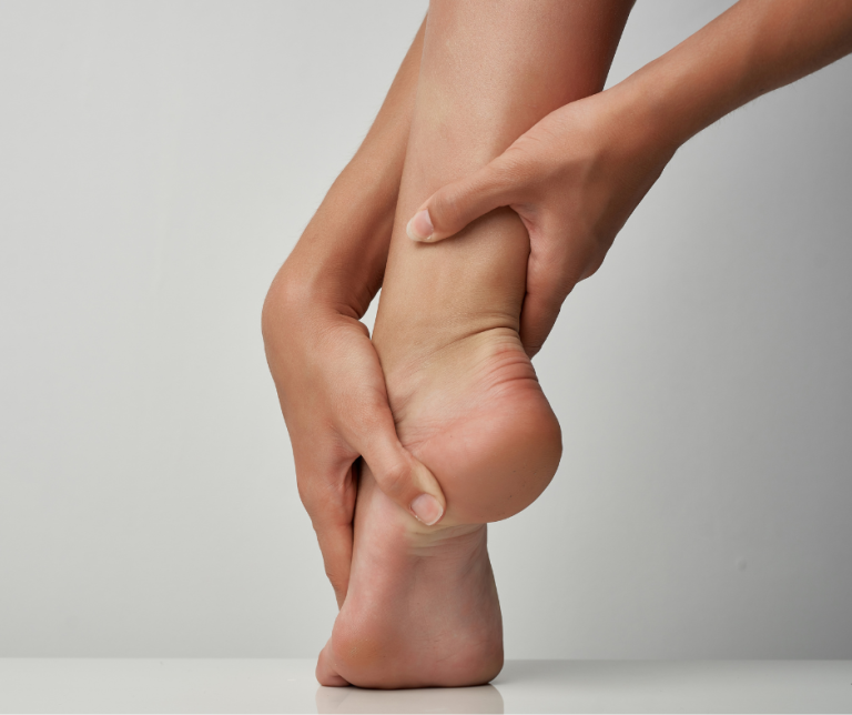 hands touching foot